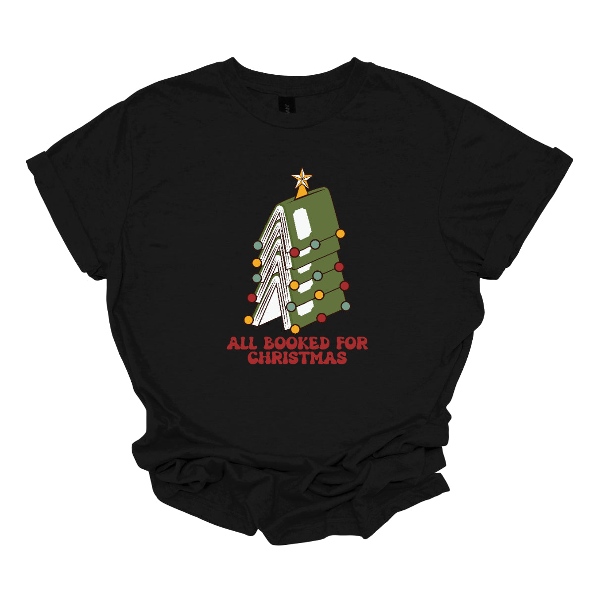 This whimsical t-shirt features the playful phrase "All Booked for Christmas" in a bold, red bubbly font that captures the festive spirit. Above the text, a delightful image showcases a stack of green books, artfully arranged to resemble a decorated Christmas tree. Shop Gorgeousware.com