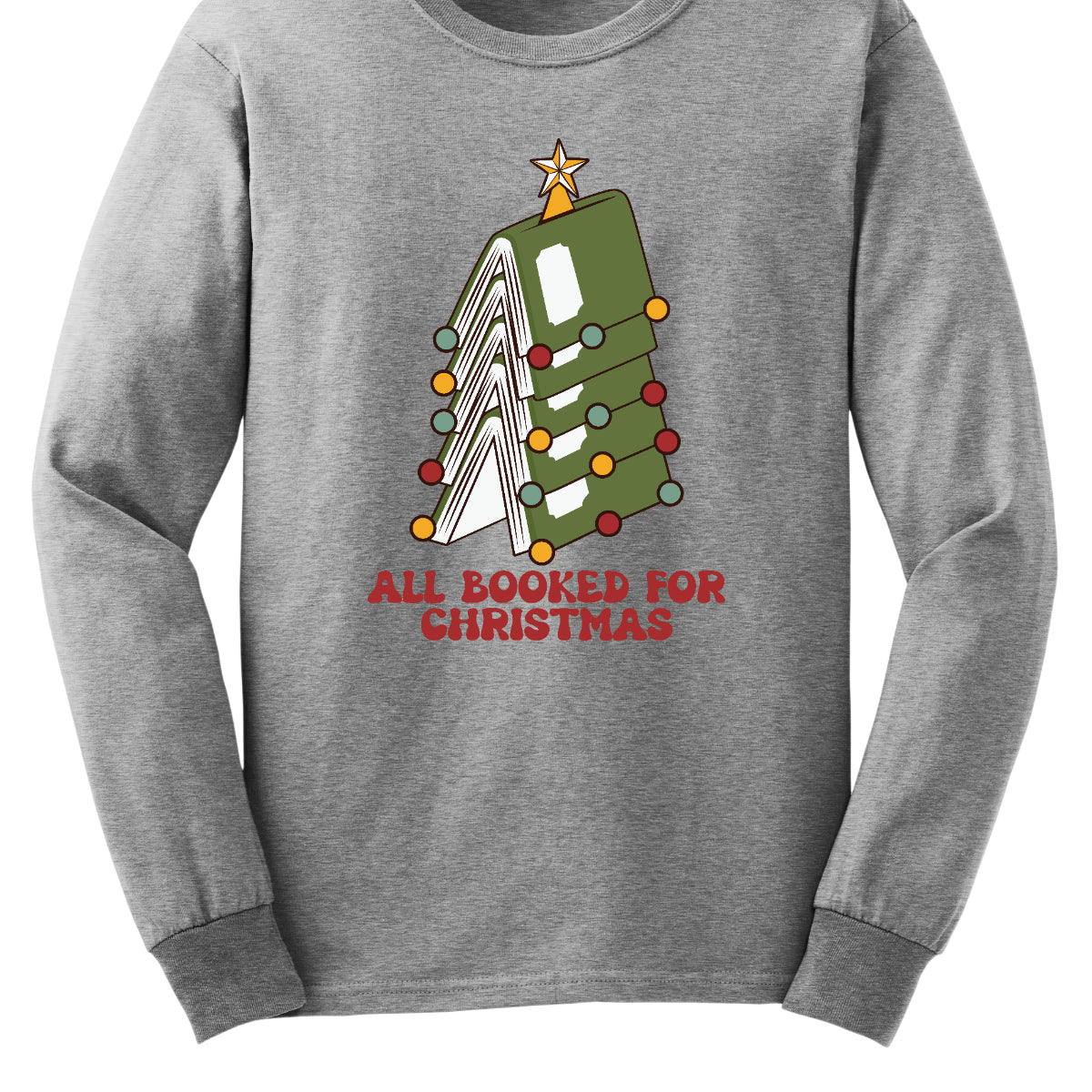 This whimsical t-shirt features the playful phrase "All Booked for Christmas" in a bold, red bubbly font that captures the festive spirit. Above the text, a delightful image showcases a stack of green books, artfully arranged to resemble a decorated Christmas tree. Shop Gorgeousware.com
