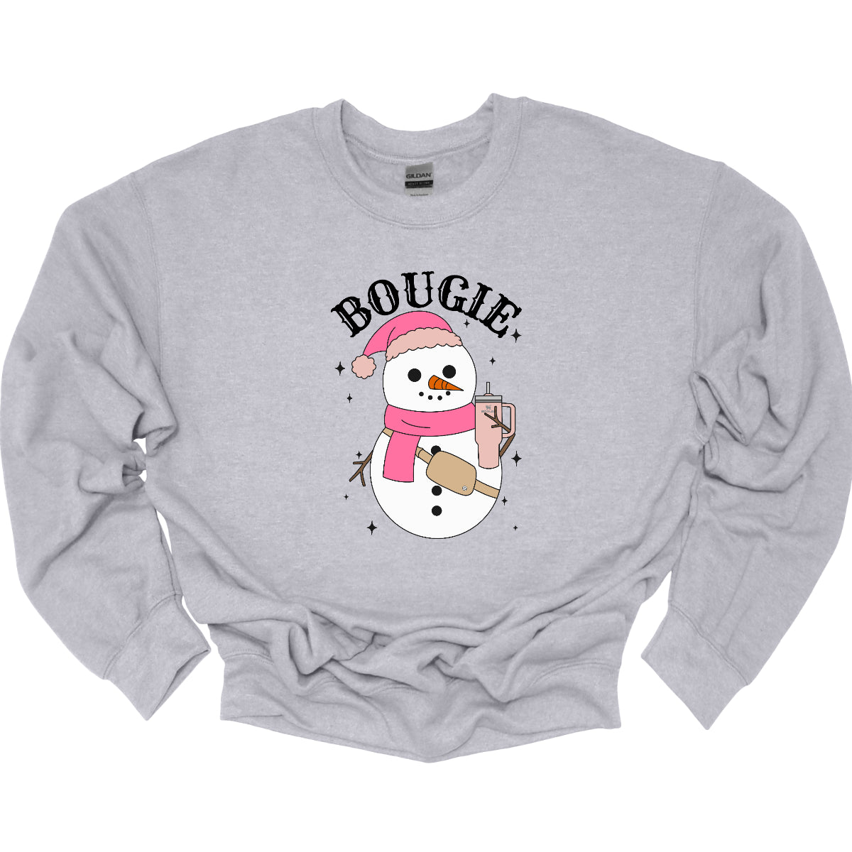 This chic t-shirt features the word "BOUGIE" in elegant, fancy lettering, capturing a stylish vibe. Beneath the text is a charming illustration of a snowman, decked out in a cute pink hat and scarf, exuding festive flair. The snowman is holding a pale pink Stanley cup, adding a trendy touch, while a beige Lululemon belt bag rests around its waist, complete with sparkles that catch the eye and enhance the glamorous theme. Shop Gorgeousware.com