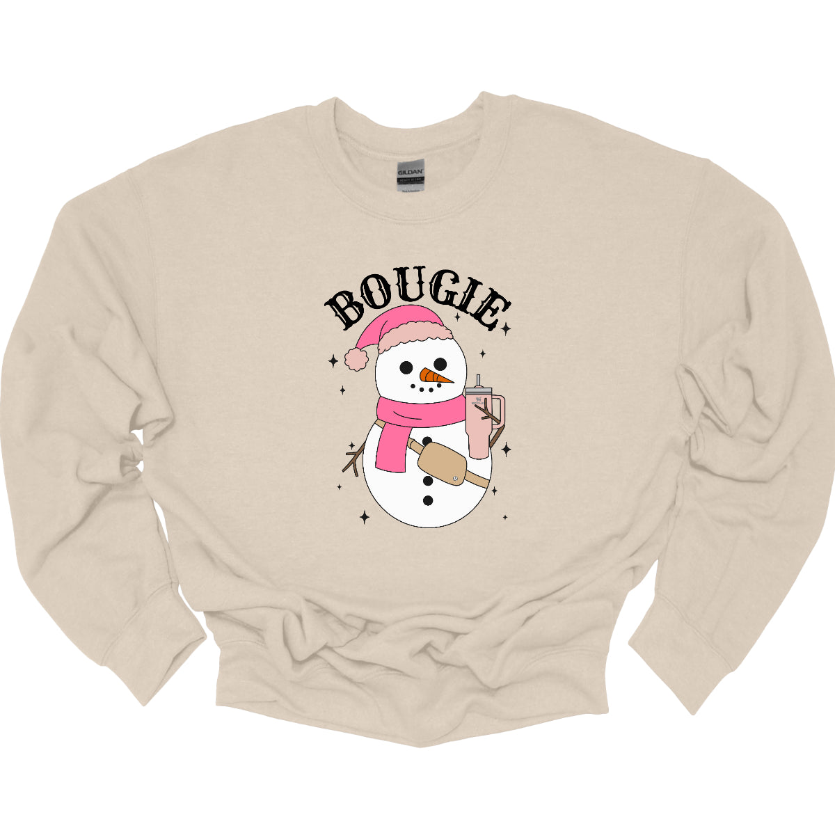 This chic t-shirt features the word "BOUGIE" in elegant, fancy lettering, capturing a stylish vibe. Beneath the text is a charming illustration of a snowman, decked out in a cute pink hat and scarf, exuding festive flair. The snowman is holding a pale pink Stanley cup, adding a trendy touch, while a beige Lululemon belt bag rests around its waist, complete with sparkles that catch the eye and enhance the glamorous theme. Shop Gorgeousware.com