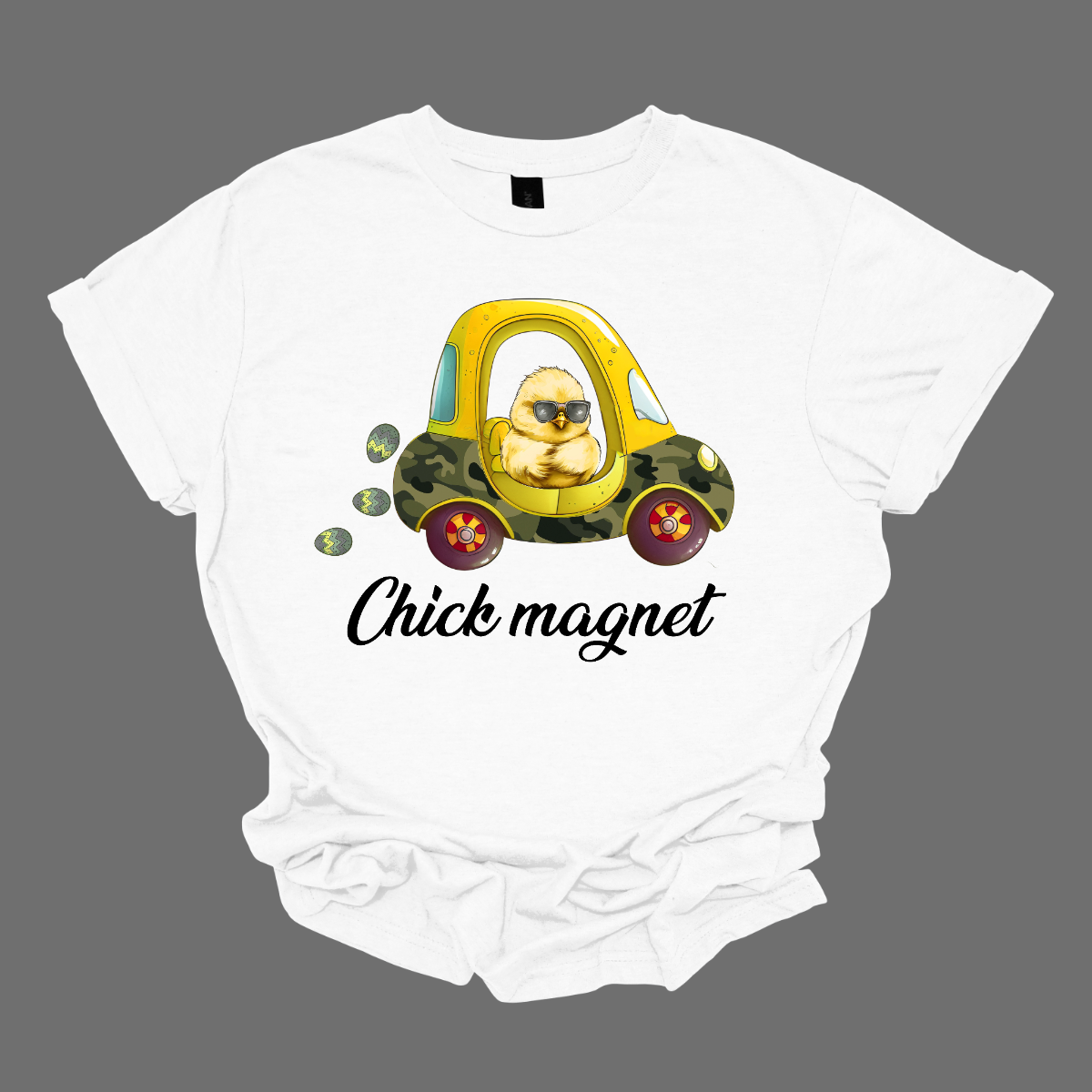"Chick Magnet" - Drive into Easter with style in our adorable t-shirt featuring a charming little chick cruising in a cozy coupe, sunglasses on and a trail of Easter eggs in its wake. This playful design is sure to turn heads and spread smiles wherever you go, capturing the fun and excitement of the holiday season. Shop at Gorgeousware.com
