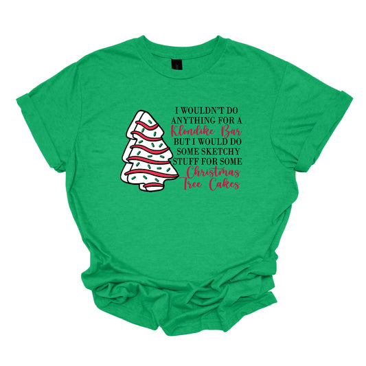 This fun t-shirt features a playful phrase: "I wouldn't do anything for a Klondike Bar but I would do some sketchy stuff for some Christmas Tree Cakes." The main text is presented in a sleek, professional black font, offering a clean contrast to the whimsical red cursive font used for "Klondike Bar" and "Christmas Tree Cakes," drawing attention to those key phrases. Shop Gorgeousware.com