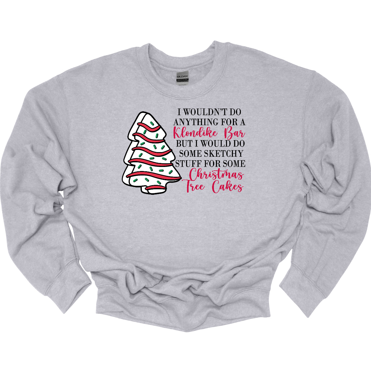 This fun t-shirt features a playful phrase: "I wouldn't do anything for a Klondike Bar but I would do some sketchy stuff for some Christmas Tree Cakes." The main text is presented in a sleek, professional black font, offering a clean contrast to the whimsical red cursive font used for "Klondike Bar" and "Christmas Tree Cakes," drawing attention to those key phrases. Shop Gorgeousware.com