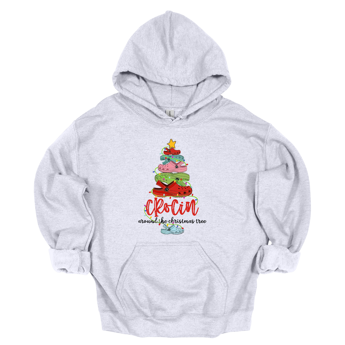 This playful t-shirt features the fun phrase "Crockin' Around the Christmas Tree" with a unique twist. The word "Crockin'" is showcased in a vibrant red cursive font, with playful spaces between the letters, adding a whimsical flair. Below that, the rest of the phrase is written in a smaller, elegant black cursive font, providing a charming contrast. Shop Gorgeousware.com