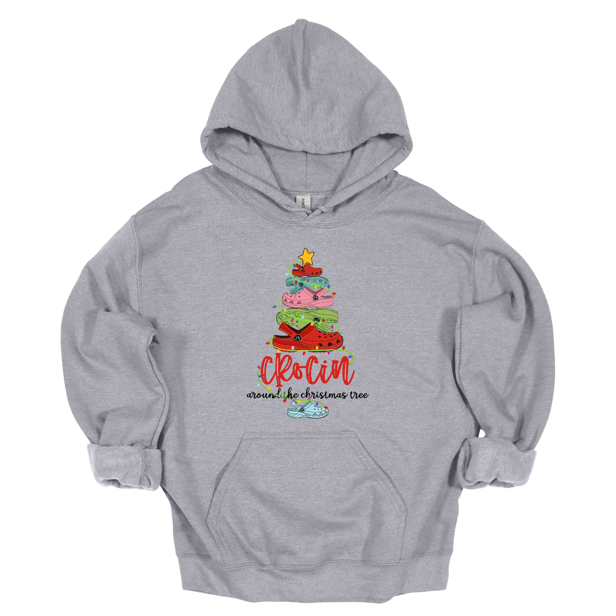 This playful t-shirt features the fun phrase "Crockin' Around the Christmas Tree" with a unique twist. The word "Crockin'" is showcased in a vibrant red cursive font, with playful spaces between the letters, adding a whimsical flair. Below that, the rest of the phrase is written in a smaller, elegant black cursive font, providing a charming contrast. Shop Gorgeousware.com