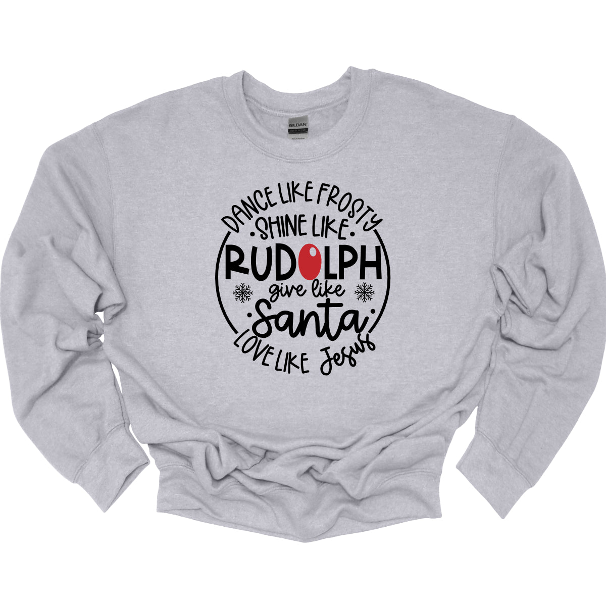 This heartwarming t-shirt features the uplifting phrase "Dance like Frosty, shine like Rudolph, give like Santa, love like Jesus" arranged in an array of stylish black fonts that create a dynamic and eye-catching design. The “O” in "Rudolph" is playfully highlighted in red, resembling his famous nose, adding a festive touch to the overall look. Shop Gorgeousware.com
