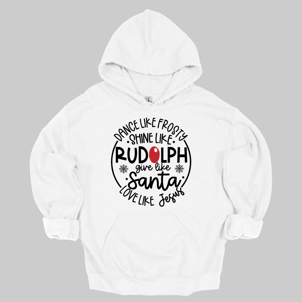 This heartwarming t-shirt features the uplifting phrase "Dance like Frosty, shine like Rudolph, give like Santa, love like Jesus" arranged in an array of stylish black fonts that create a dynamic and eye-catching design. The “O” in "Rudolph" is playfully highlighted in red, resembling his famous nose, adding a festive touch to the overall look. Shop Gorgeousware.com