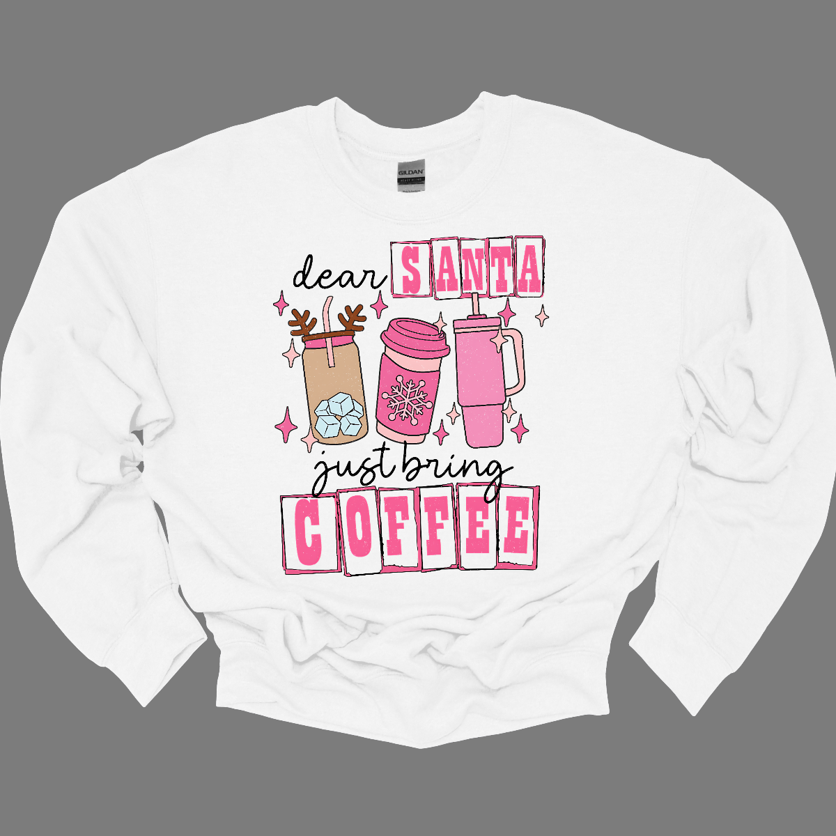 holiday season isn't complete without a little caffeine boost! The design features the cheeky phrase, "Dear Santa, Just bring coffee", in bold, fun lettering. The words "Santa" and "coffee" are highlighted with hot pink block-outlined boxes, adding a pop of color and flair to the design. Shop at Gorgeousware.com