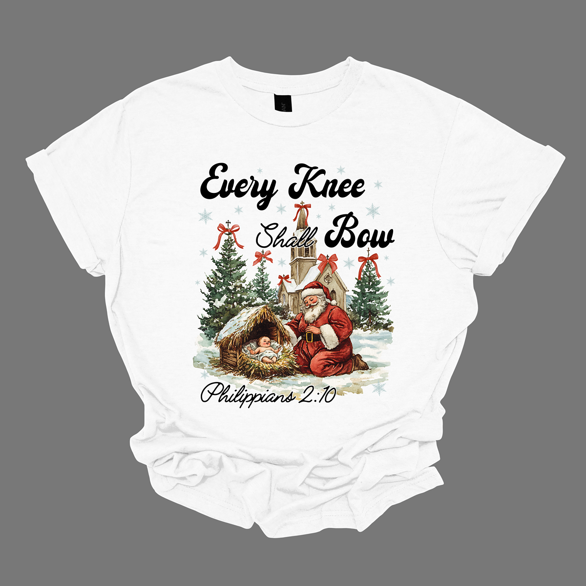This festive and powerful apparel design features the phrase "Every Knee Shall Bow" in bold, elegant lettering, symbolizing the reverence and humility of the Christmas story. The artwork showcases Santa Claus, traditionally known for his joyful spirit, bowing down in awe before a humble manger that cradles baby Jesus. In the background, an old chapel stands as a symbol of faith, with evergreen trees adorned with festive bows, adding a touch of seasonal beauty and serenity. Shop at Gorgeousware.com