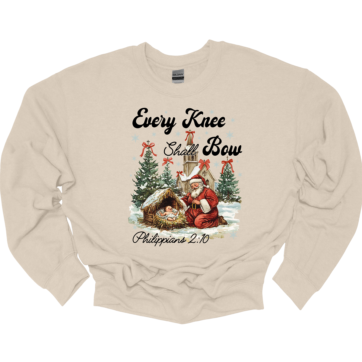 This festive and powerful apparel design features the phrase "Every Knee Shall Bow" in bold, elegant lettering, symbolizing the reverence and humility of the Christmas story. The artwork showcases Santa Claus, traditionally known for his joyful spirit, bowing down in awe before a humble manger that cradles baby Jesus. In the background, an old chapel stands as a symbol of faith, with evergreen trees adorned with festive bows, adding a touch of seasonal beauty and serenity. Shop at Gorgeousware.com