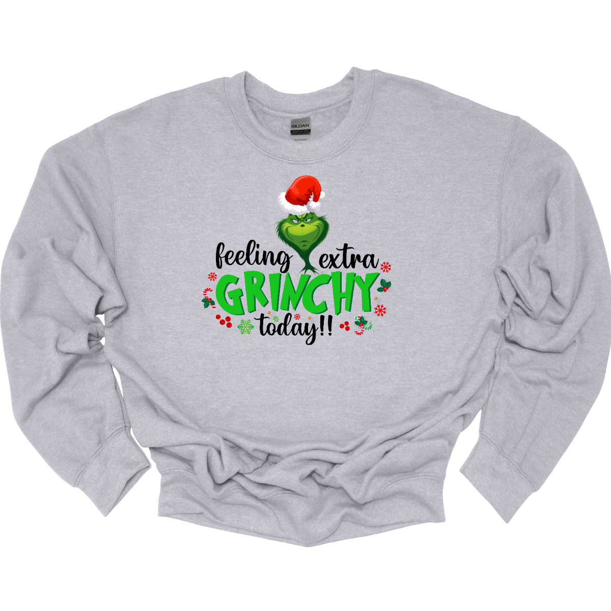 This T-shirt design exudes festive cheer and playful humor with its vibrant and eye-catching elements. The front of the shirt features the phrase, "Feeling extra grinchy today!!" prominently displayed in a fun and engaging. Shop Gorgeousware.com