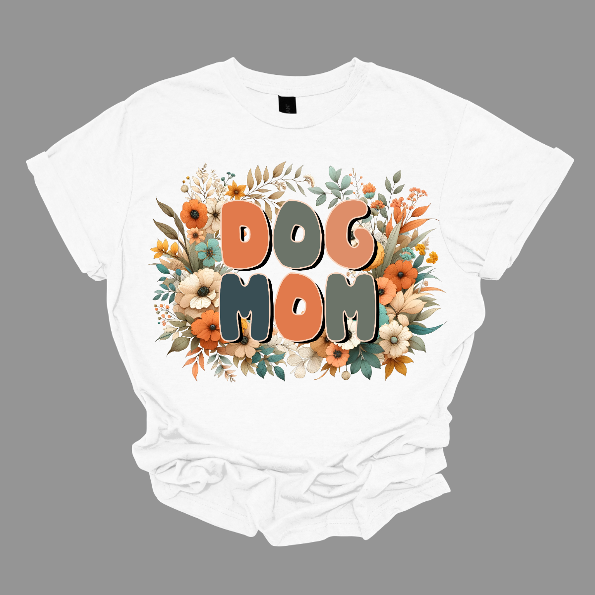 This Floral Dog Mom Shirt features a fun and playful font that reads "Dog Mom" in bold, eye-catching letters. The design is adorned with delicate, vibrant flowers in shades of pink and blue, adding a touch of nature’s beauty to the overall look. The combination of the lively, floral accents and the cheerful typography makes this shirt a perfect way to showcase your love for your furry friend in a stylish and feminine way. Shop Gorgeouseware.com