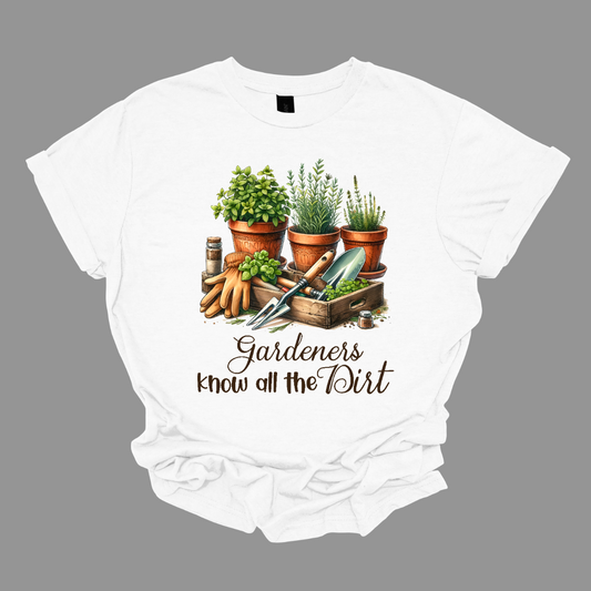 The shirt design features the phrase "Gardeners Know All the Dirt" in an elegant script lettering style, giving it a charming and organic feel. Surrounding the text are potted plants in various shapes and sizes.
Additionally, the design incorporates gardening tools like a trowel, rake, watering can, and gloves, subtly placed around the lettering to enhance the theme. Earthy tones like green, brown, and earth tones dominate . Shop Gorgeouseware.com