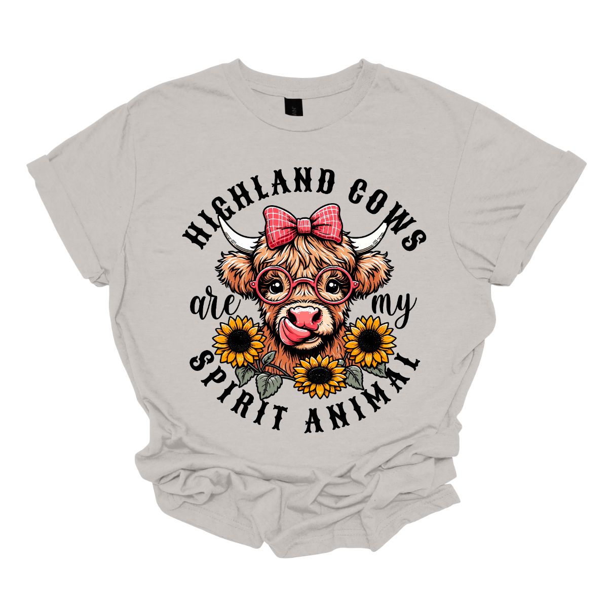 This shirt showcases a delightful Highland cow, complete with a cute bow on its head and stylish glasses, radiating charm and personality. Beneath the cow, a lovely arrangement of yellow daisies creates a soft, floral touch, adding a pop of color and whimsy to the design. The phrase "Highland Cows are my spirit animal" is playfully displayed, capturing the cow's spirit and the wearer's connection to these unique creatures. Shop Gorgeouseware.com