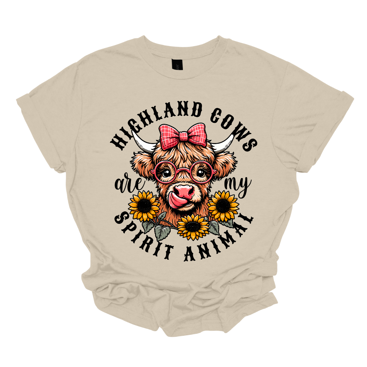 This shirt showcases a delightful Highland cow, complete with a cute bow on its head and stylish glasses, radiating charm and personality. Beneath the cow, a lovely arrangement of yellow daisies creates a soft, floral touch, adding a pop of color and whimsy to the design. The phrase "Highland Cows are my spirit animal" is playfully displayed, capturing the cow's spirit and the wearer's connection to these unique creatures. Shop Gorgeouseware.com