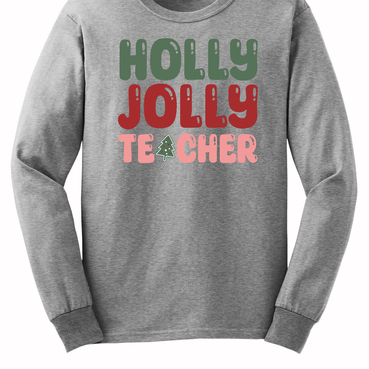 This festive t-shirt features the cheerful phrase "Holly Jolly Teacher" in a delightful bubbly font with fun cut-outs that add a playful touch. The word "Holly" is presented in a vibrant green, evoking the essence of holiday greenery, while "Jolly" pops in a bright red, radiating festive cheer. The word "Teacher" is in a cheerful pink, providing a lovely contrast. A whimsical twist comes with the letter "A" in "Teacher," which is creatively transformed into a charming Christmas tree. Shop Gorgeousware.com