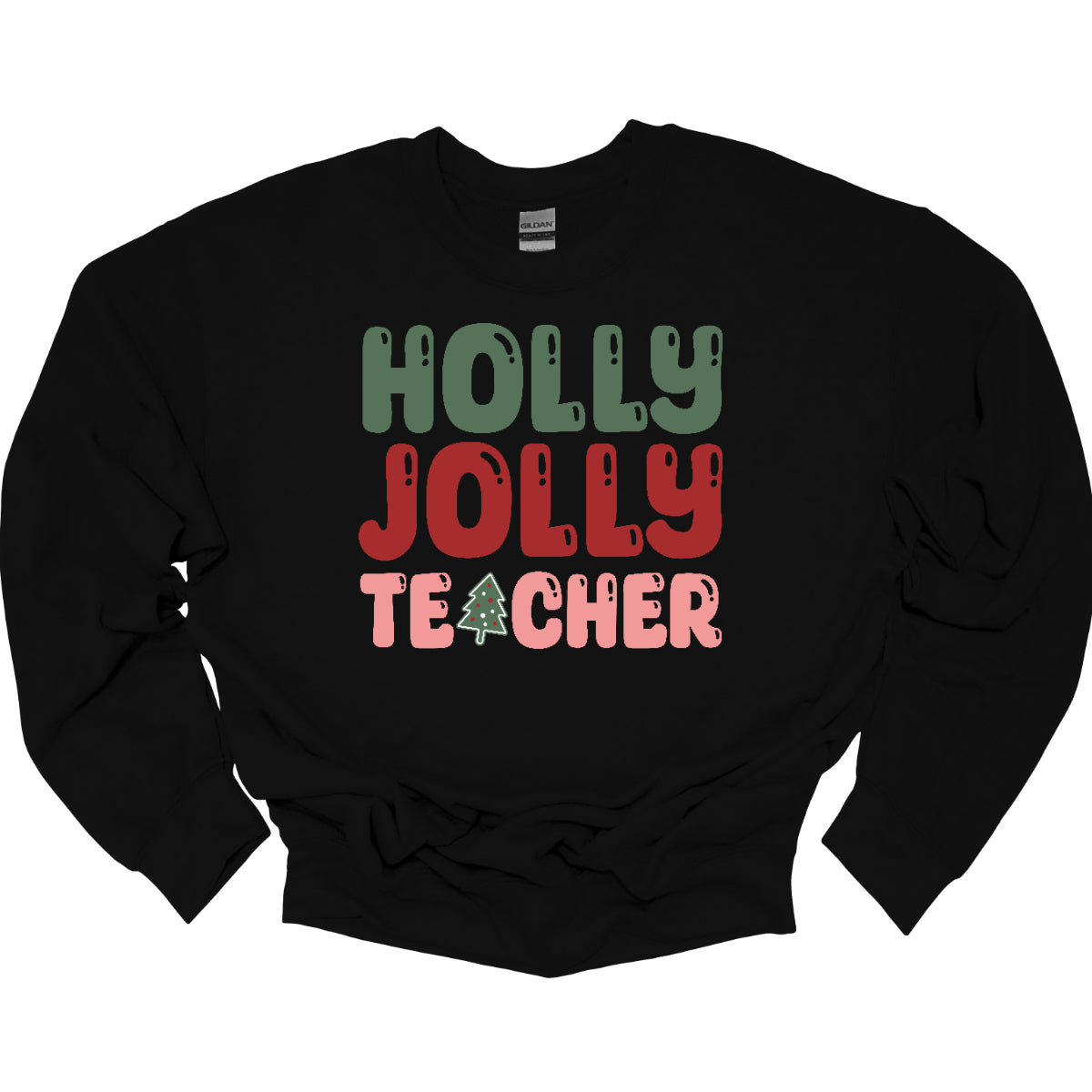 This festive t-shirt features the cheerful phrase "Holly Jolly Teacher" in a delightful bubbly font with fun cut-outs that add a playful touch. The word "Holly" is presented in a vibrant green, evoking the essence of holiday greenery, while "Jolly" pops in a bright red, radiating festive cheer. The word "Teacher" is in a cheerful pink, providing a lovely contrast. A whimsical twist comes with the letter "A" in "Teacher," which is creatively transformed into a charming Christmas tree. Shop Gorgeousware.com