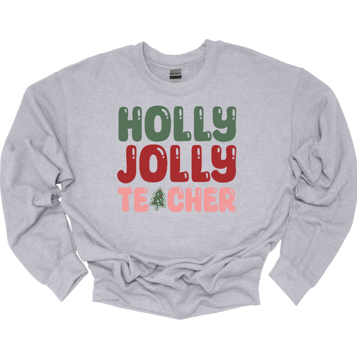 This festive t-shirt features the cheerful phrase "Holly Jolly Teacher" in a delightful bubbly font with fun cut-outs that add a playful touch. The word "Holly" is presented in a vibrant green, evoking the essence of holiday greenery, while "Jolly" pops in a bright red, radiating festive cheer. The word "Teacher" is in a cheerful pink, providing a lovely contrast. A whimsical twist comes with the letter "A" in "Teacher," which is creatively transformed into a charming Christmas tree. Shop Gorgeousware.com