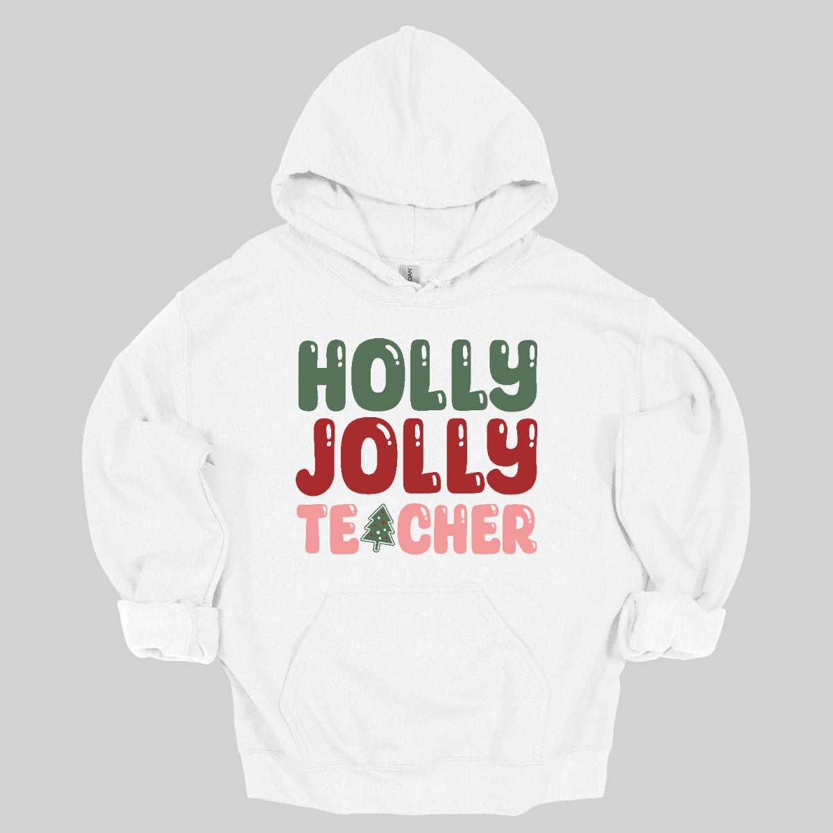 This festive t-shirt features the cheerful phrase "Holly Jolly Teacher" in a delightful bubbly font with fun cut-outs that add a playful touch. The word "Holly" is presented in a vibrant green, evoking the essence of holiday greenery, while "Jolly" pops in a bright red, radiating festive cheer. The word "Teacher" is in a cheerful pink, providing a lovely contrast. A whimsical twist comes with the letter "A" in "Teacher," which is creatively transformed into a charming Christmas tree. Shop Gorgeousware.com