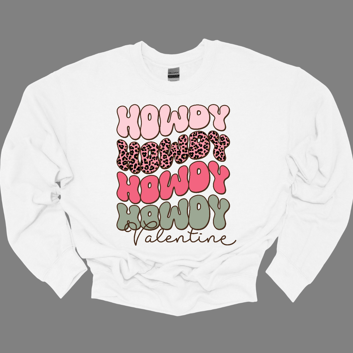 Introducing our "Howdy Valentine" T-shirt – a retro-inspired masterpiece that adds a touch of vintage charm to your Valentine's Day celebration. This shirt features a stylish retro font in soft pinks and sage colors, creating a delightful and nostalgic vibe perfect for expressing love with a Western twist. The phrase "Howdy Valentine" is elegantly displayed in a retro font, evoking the classic aesthetics of bygone eras. Shop at Gorgeousware.com