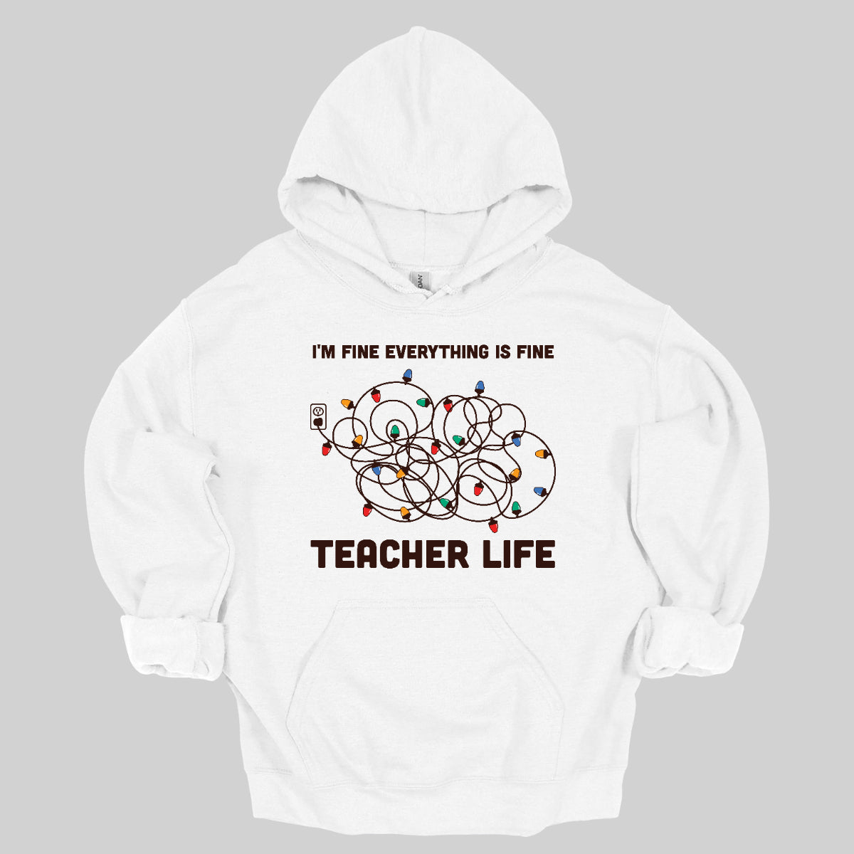 This humorous t-shirt features the phrase "I'm fine, everything is fine" in bold, playful lettering, perfectly capturing that relatable holiday vibe. Below the text, there's a whimsical illustration of a tangled wad of Christmas lights plugged into an outlet, humorously representing the chaos that can come with the season. Underneath the lights, the words "Teacher Life" are displayed, adding a clever nod to the unique challenges teachers face, especially during the festive rush. Shop at Gorgeousware.com