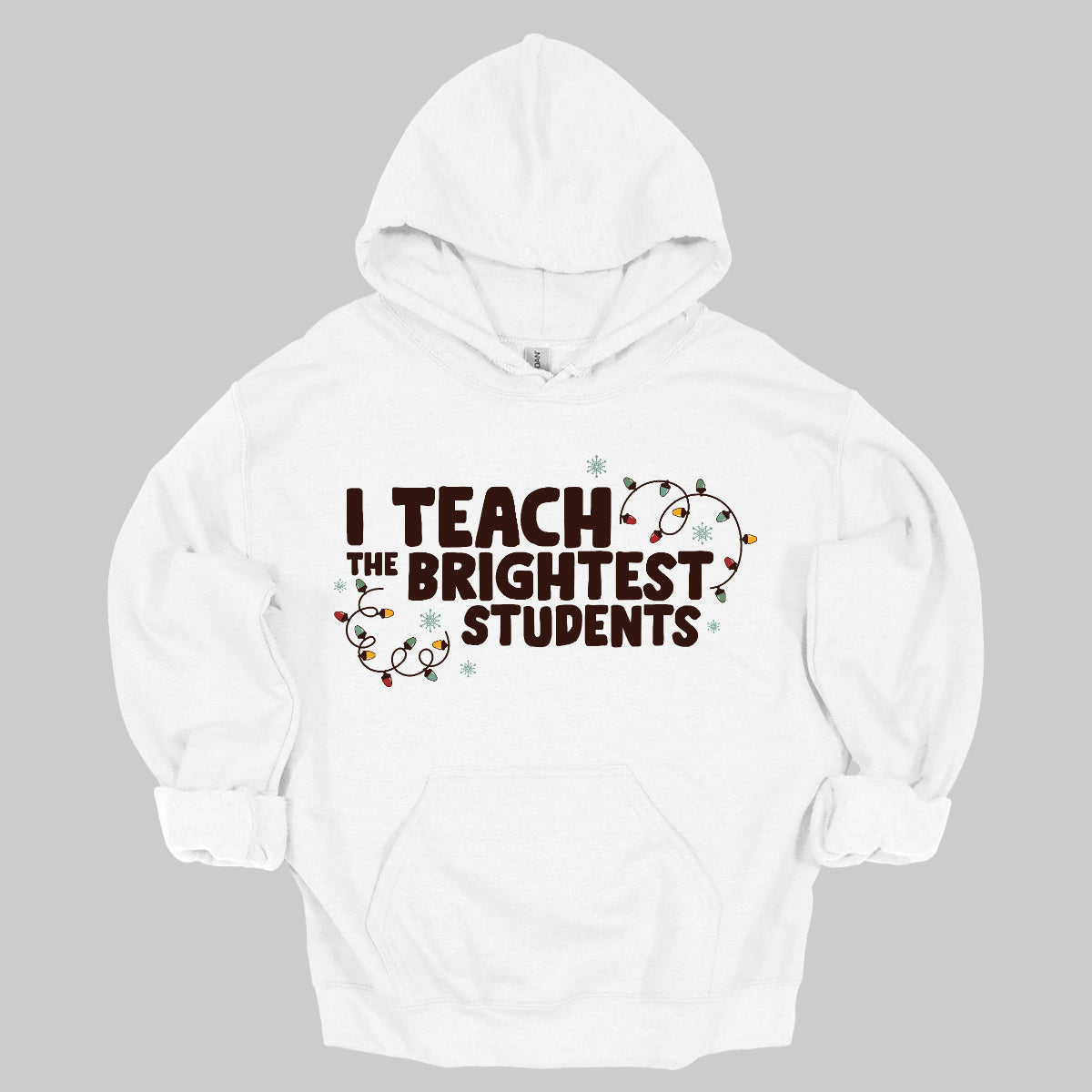 Celebrate your passion for teaching with our "I Teach the Brightest Students" t-shirt! This fun and festive design features cheerful Christmas lights framing the text, adding a touch of holiday spirit to your classroom vibe. Made from soft, comfortable fabric, it’s perfect for wearing during the festive season or any day you want to show off your pride in your students. Brighten up your wardrobe and spread some joy—because every great teacher deserves to