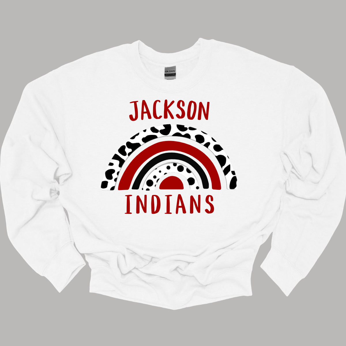 Show off your unique Indian spirit with our Jackson Indians apparel featuring a one-of-a-kind design! This eye-catching piece highlights a whimsical rainbow pattern, infused with a bold cheetah print for an adventurous twist. The playful rainbow arcs across the design, blending vibrant colors with the fierce, energetic vibe of the cheetah print. At the heart of it all, the Jackson Indians logo stands proudly, ensuring your school pride shines through. Shop at Gorgeousware.com