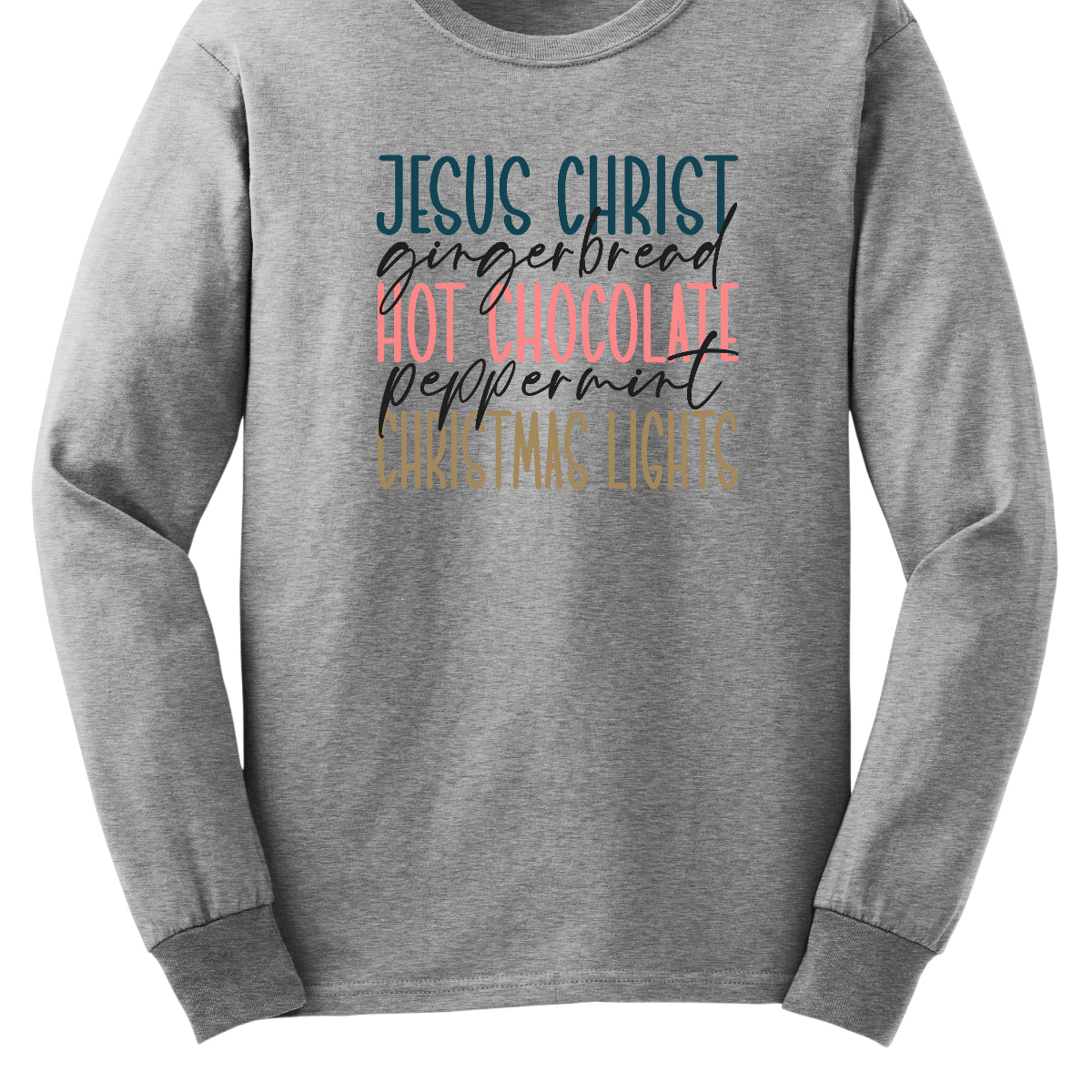 This festive t-shirt showcases a vibrant design with the phrase "JESUS CHRIST," "gingerbread," "HOT CHOCOLATE," "peppermint," and "CHRISTMAS LIGHTS" arranged vertically down the shirt. The words "JESUS CHRIST," "HOT CHOCOLATE," and "CHRISTMAS LIGHTS" are all in bold capital letters, each presented in a different bright color, creating a cheerful and eye-catching effect. Shop Gorgeousware.com