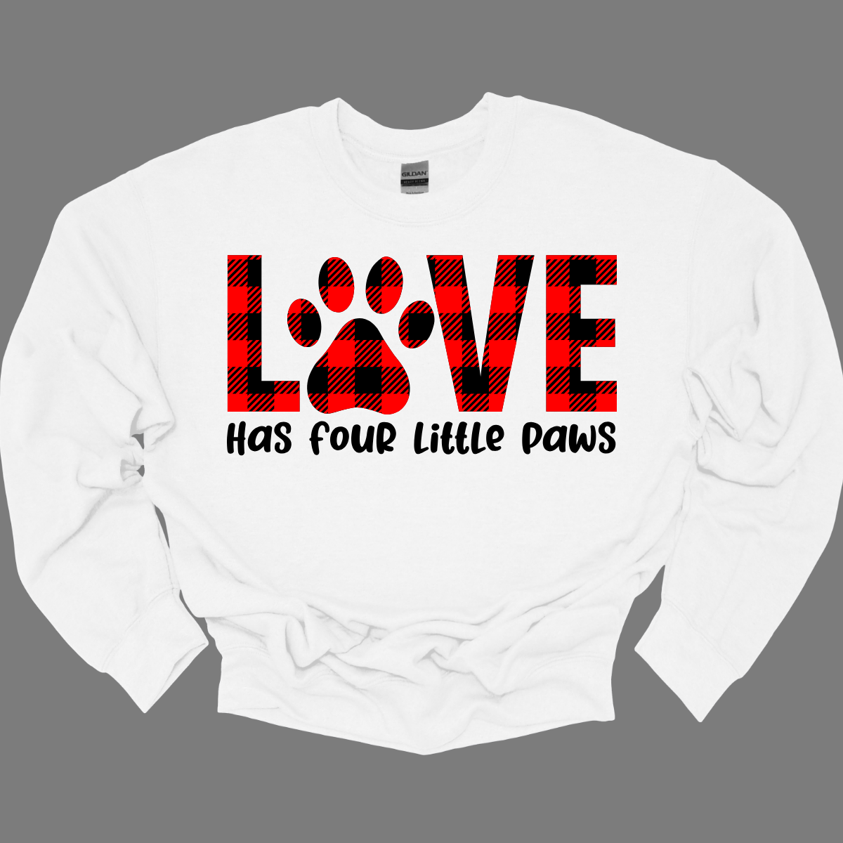 Declare your love for furry companions with our 'LOVE has Four Little Paws' T-shirt, featuring an adorable paw print in black and red plaid and a paw as the 'O'. This tee is a heartwarming tribute to the joy that pets bring into our lives. The charming plaid design adds a touch of rustic  charm, creating a perfect blend of style and sentiment. Shop at Gorgeousware.com today!