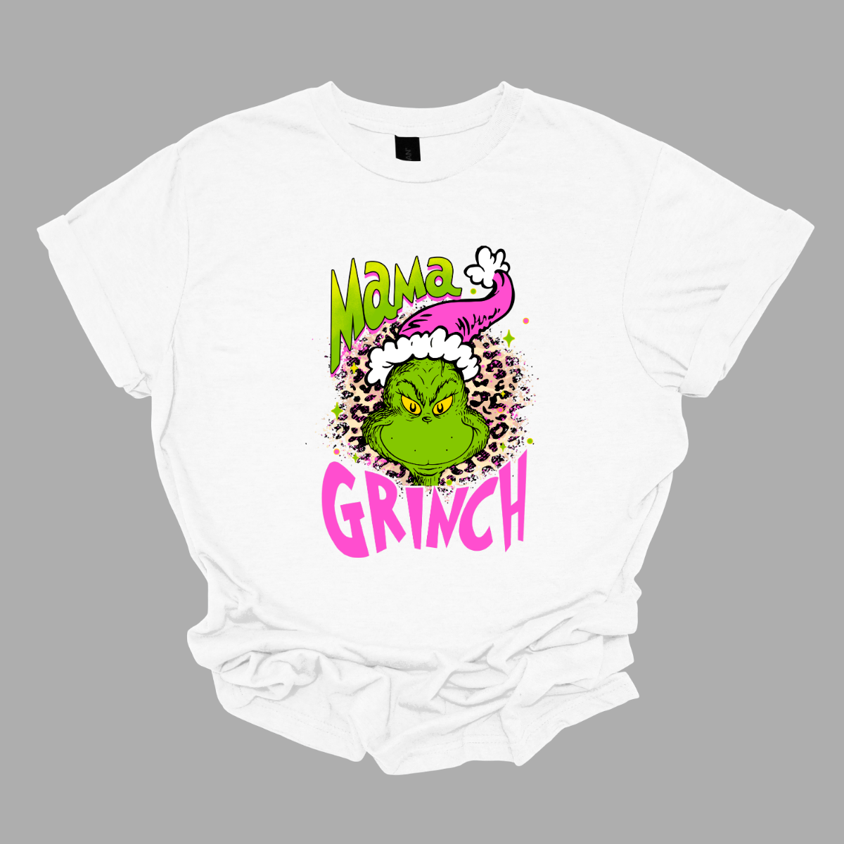 At the center of the design is the phrase "Mama Grinch," rendered in a whimsical, Grinch-style font. The word "Mama" pops in a vibrant green color with a delicate pink shadow that adds a touch of charm. The word "Grinch" contrasts in a bold, eye-catching pink that stands out against the green. Between the two words, there's a delightful illustration of the Grinch himself. He's sporting a cute pink and white Santa hat, which adds a fun and seasonal flair. Shop Gorgeousware.com
