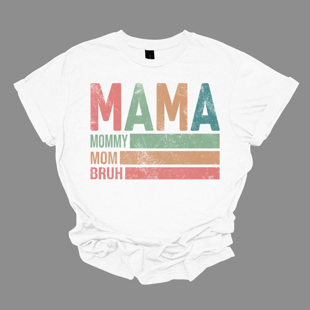 This shirt features a playful and vibrant design with the words "Mama, Mommy, Mom, Bruh" in a fun, eye-catching font. The text is arranged in a bold, dynamic style, giving it a laid-back, modern feel. The shirt’s color palette is a mix of cool tones, blending rose pine, mustard yellow, green, and blue. These colors come together to create a relaxed yet energetic vibe. Shop Gorgeousware.com