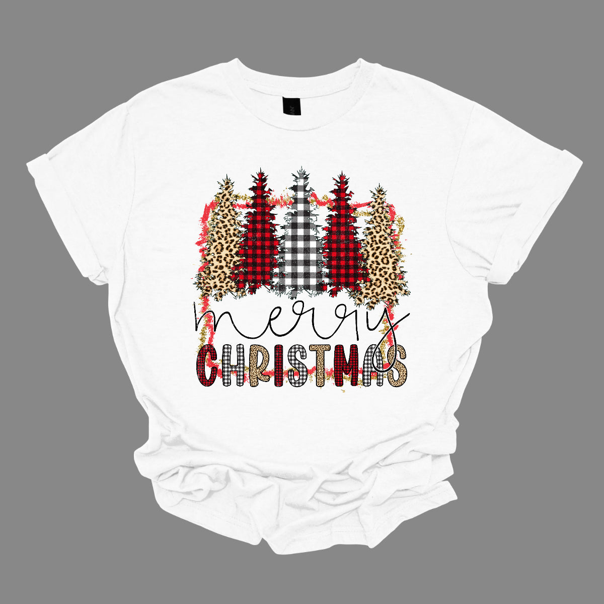 This festive t-shirt showcases the playful phrase "Merry Christmas." The word "Merry" is elegantly rendered in a fine line black cursive, giving it a classic touch. Below, "Christmas" features a lively bubbly font that alternates between red and black plaid, white and black plaid, and cheetah print, adding a fun and trendy vibe. Shop Gorgeousware.com