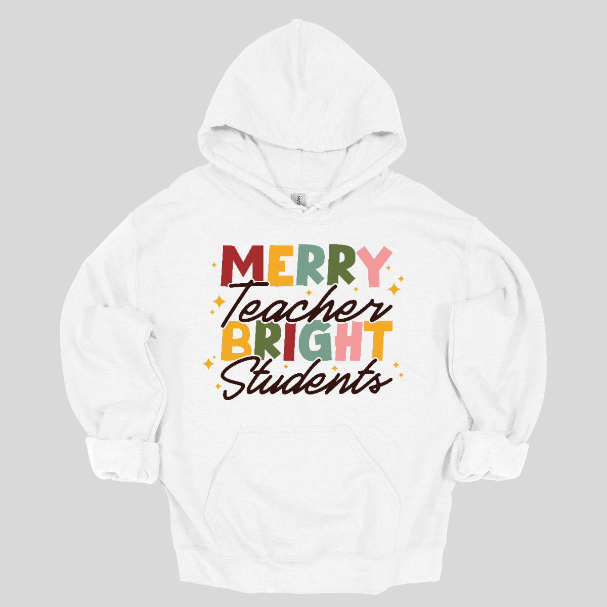 This festive t-shirt showcases the cheerful phrase "Merry Teacher Bright Students" in a delightful design. The words "MERRY" and "BRIGHT" are prominently featured in a blocky yet playful font, with each letter bursting in a vibrant mix of shades of green and red, evoking the spirit of the holiday season. Shop Gorgeousware.com