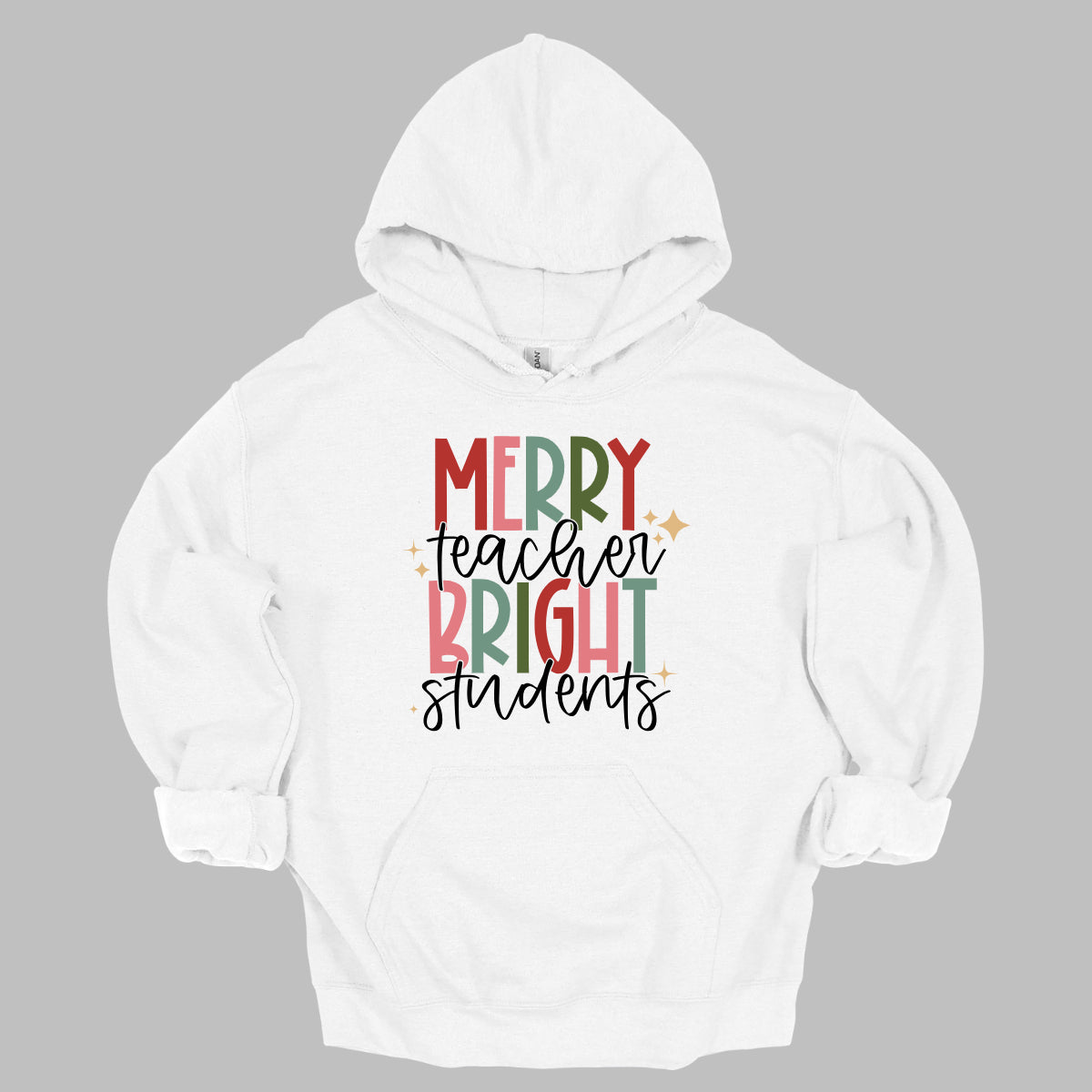 This festive t-shirt showcases the cheerful phrase "Merry Teacher Bright Students" in a delightful design. The words "MERRY" and "BRIGHT" are prominently featured in a blocky yet playful font, with each letter bursting in a vibrant mix of shades of green and red, evoking the spirit of the holiday season. Shop Gorgeousware.com
