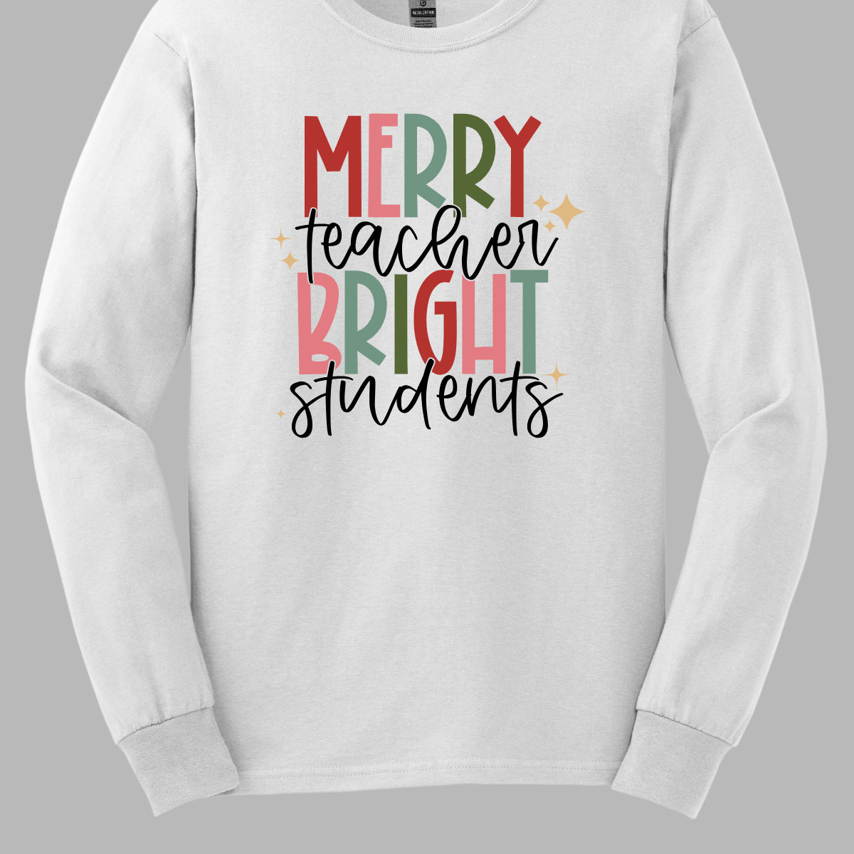 This festive t-shirt showcases the cheerful phrase "Merry Teacher Bright Students" in a delightful design. The words "MERRY" and "BRIGHT" are prominently featured in a blocky yet playful font, with each letter bursting in a vibrant mix of shades of green and red, evoking the spirit of the holiday season. Shop Gorgeousware.com