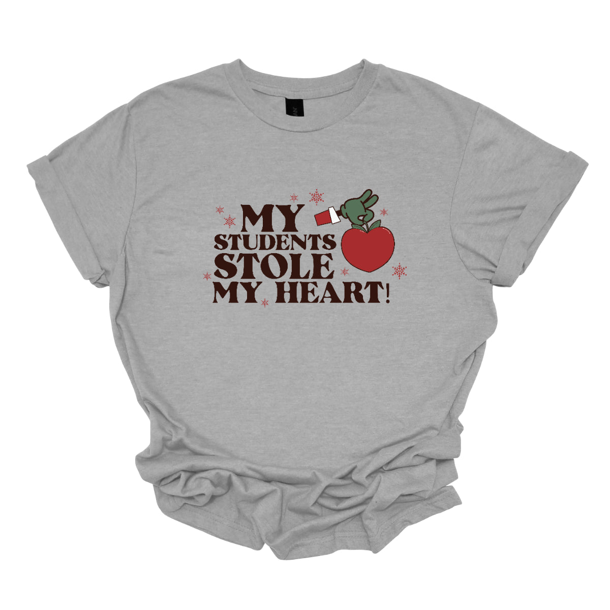 This playful t-shirt features the phrase "My students stole my heart" in fun, whimsical lettering that captures the spirit of teaching. Below the text, a cheeky illustration of the Grinch's green arm emerges, playfully grasping a shiny red apple, symbolizing knowledge and education. Shop at Gorgeousware.com