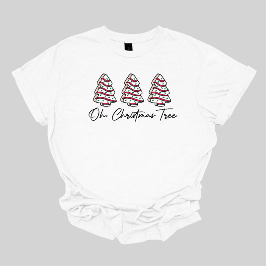 This t-shirt features a whimsical holiday design that’s perfect for spreading cheer. The shirt is adorned with the phrase “Oh Christmas Tree” written in elegant black cursive font, adding a touch of sophistication to the festive message. Above the words, three iconic Christmas tree snack cakes are illustrated, each depicted with their classic, playful decorations. Shop Gorgeousware.com