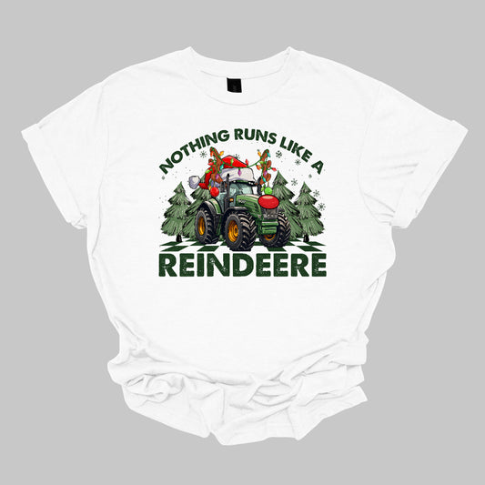 This playful t-shirt features the catchy phrase "Nothing runs like a reindeer" in bold black font, making a fun statement that’s perfect for the holiday season. At the center of the shirt, a charming John Deere tractor is decked out for Christmas: it sports a bright red nose, festive antlers, and a classic Santa hat, creating a delightful and humorous twist. The tractor is surrounded by whimsical Christmas trees, adding a cheerful backdrop that enhances the festive vibe. Shop Gorgeousware.com