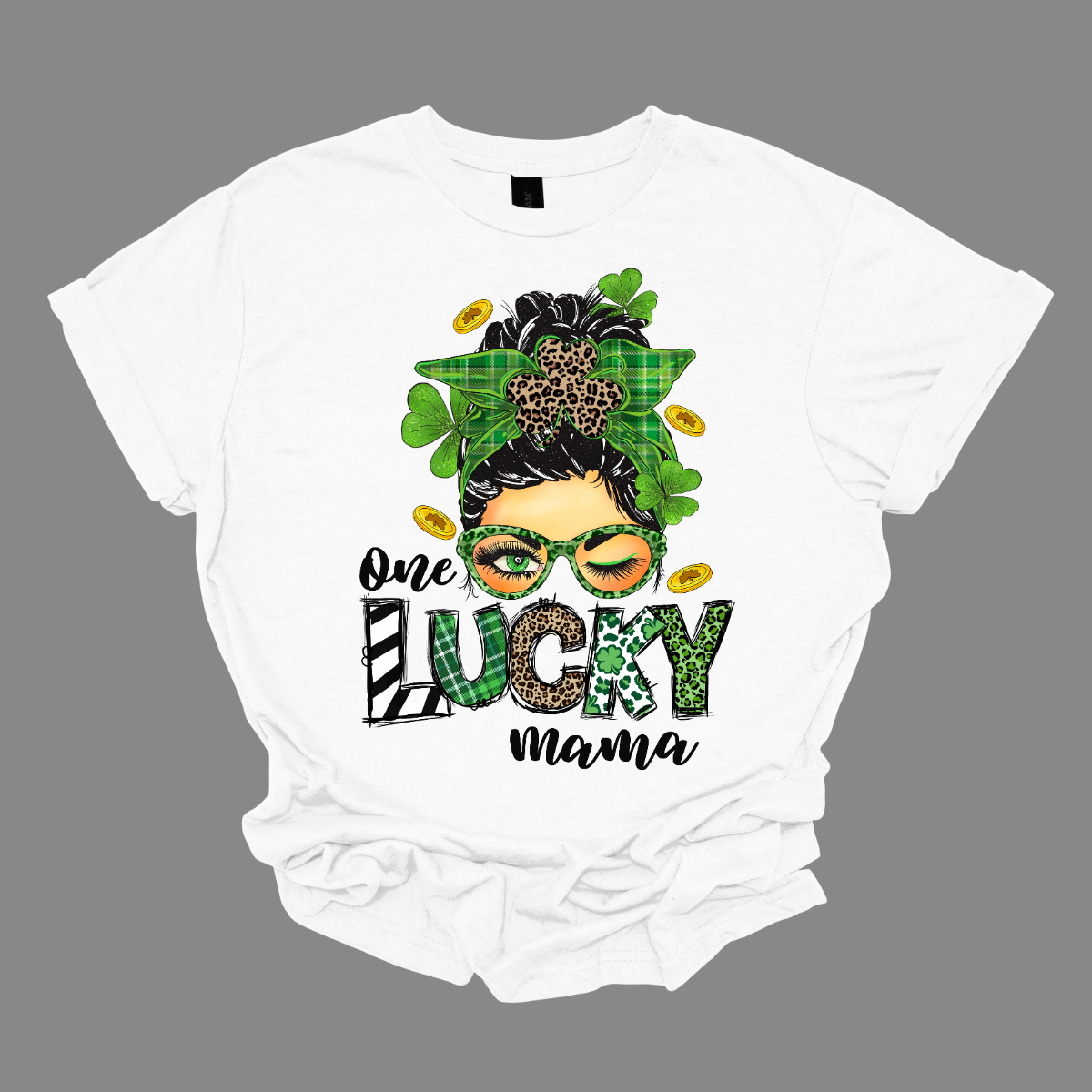 Embrace your mom pride with our charming "One Lucky Mama" T-shirt! This adorable design features a whimsical illustration of a mom sporting a messy updo and trendy green glasses, exuding a fun and carefree vibe. Celebrate the joy of motherhood in style with our "One Lucky Mama" T-shirt. It's a must-have addition to your wardrobe and also makes a thoughtful gift for any proud mama in your life. Wear it with pride and let the world know just how lucky you feel to be a mom! Shop at Gorgeousware.com