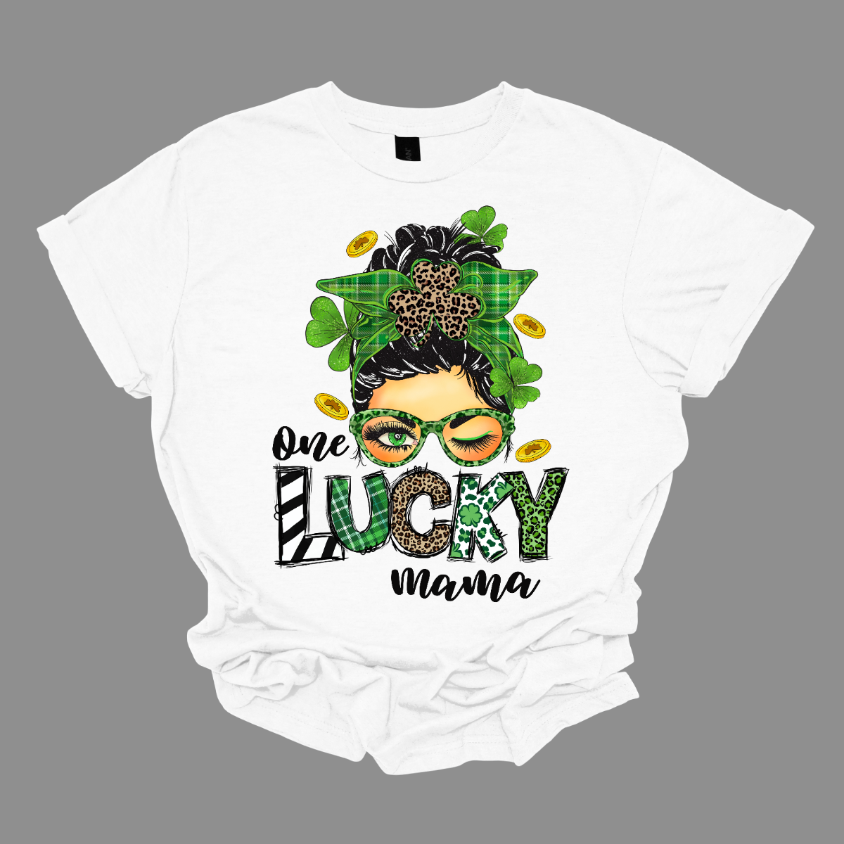 Embrace your mom pride with our charming "One Lucky Mama" T-shirt! This adorable design features a whimsical illustration of a mom sporting a messy updo and trendy green glasses, exuding a fun and carefree vibe. Celebrate the joy of motherhood in style with our "One Lucky Mama" T-shirt. It's a must-have addition to your wardrobe and also makes a thoughtful gift for any proud mama in your life. Wear it with pride and let the world know just how lucky you feel to be a mom! Shop at Gorgeousware.com