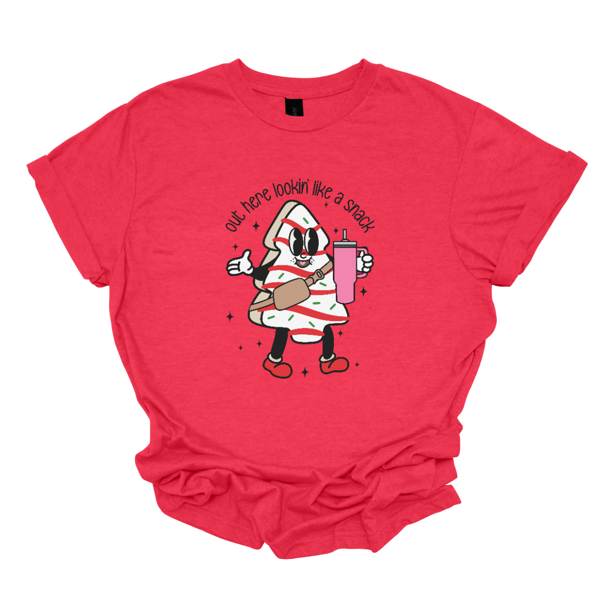 This playful t-shirt features the phrase "Out here lookin' like a snack" in a bold black stick figure font, giving it a fun and casual vibe. Beneath the text, a charming cartoon Christmas tree cake adds a whimsical touch, complete with a cheerful smiling face, a stylish belt bag, and a cup. The surrounding sparkles enhance the festive spirit, making this shirt a delightful choice for spreading holiday cheer with a humorous twist! Shop Gorgeousware.com