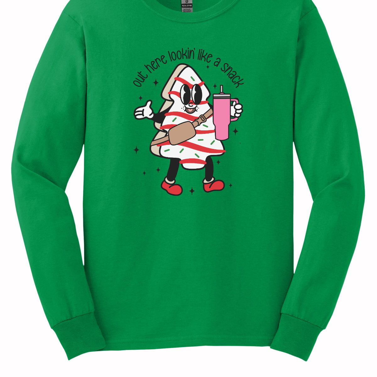 This playful t-shirt features the phrase "Out here lookin' like a snack" in a bold black stick figure font, giving it a fun and casual vibe. Beneath the text, a charming cartoon Christmas tree cake adds a whimsical touch, complete with a cheerful smiling face, a stylish belt bag, and a cup. The surrounding sparkles enhance the festive spirit, making this shirt a delightful choice for spreading holiday cheer with a humorous twist! Shop Gorgeousware.com