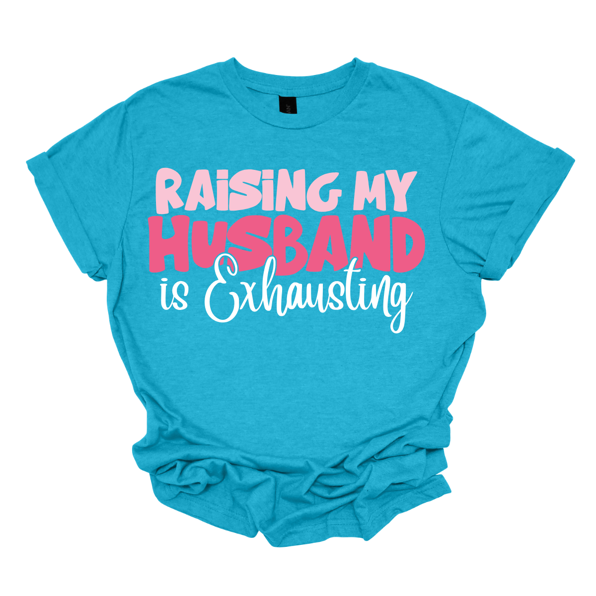 This T-shirt features the humorous phrase "Raising My Husband Is Exhausting" prominently across the chest. The text is creatively arranged in a mix of playful and quirky fonts, each each line standing out with a unique style. The color palette is a soft and vibrant pink, with a varying shade to enhance the fun and lighthearted vibe of the design. Shop at Gorgeousware.com