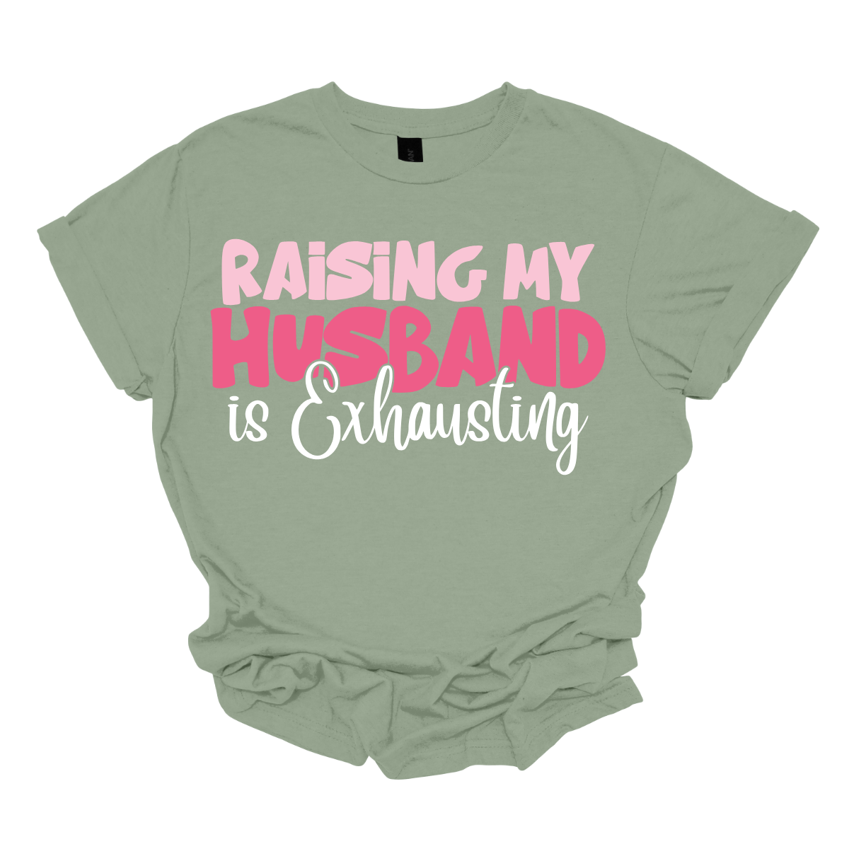 This T-shirt features the humorous phrase "Raising My Husband Is Exhausting" prominently across the chest. The text is creatively arranged in a mix of playful and quirky fonts, each each line standing out with a unique style. The color palette is a soft and vibrant pink, with a varying shade to enhance the fun and lighthearted vibe of the design. Shop at Gorgeousware.com