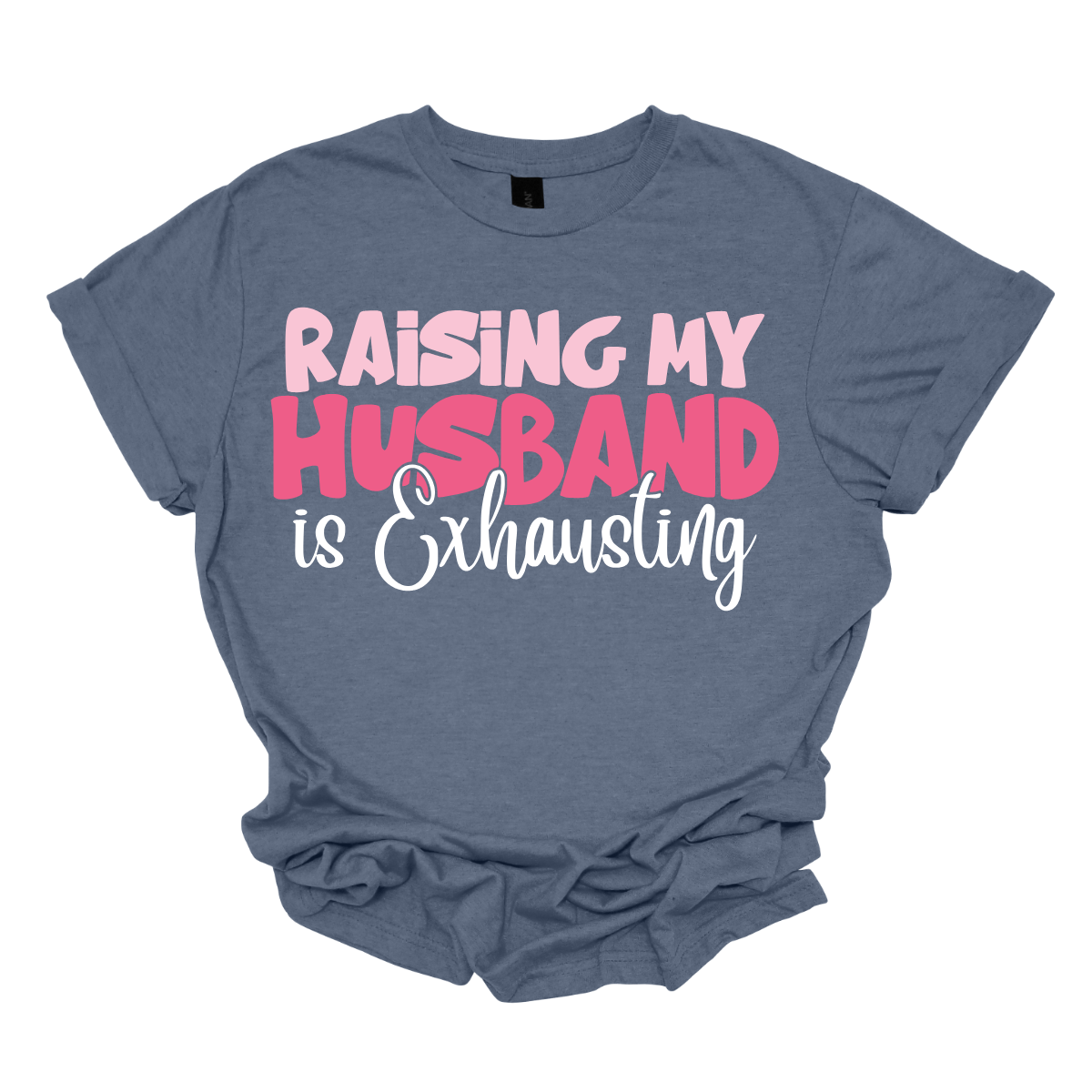 This T-shirt features the humorous phrase "Raising My Husband Is Exhausting" prominently across the chest. The text is creatively arranged in a mix of playful and quirky fonts, each each line standing out with a unique style. The color palette is a soft and vibrant pink, with a varying shade to enhance the fun and lighthearted vibe of the design. Shop at Gorgeousware.com