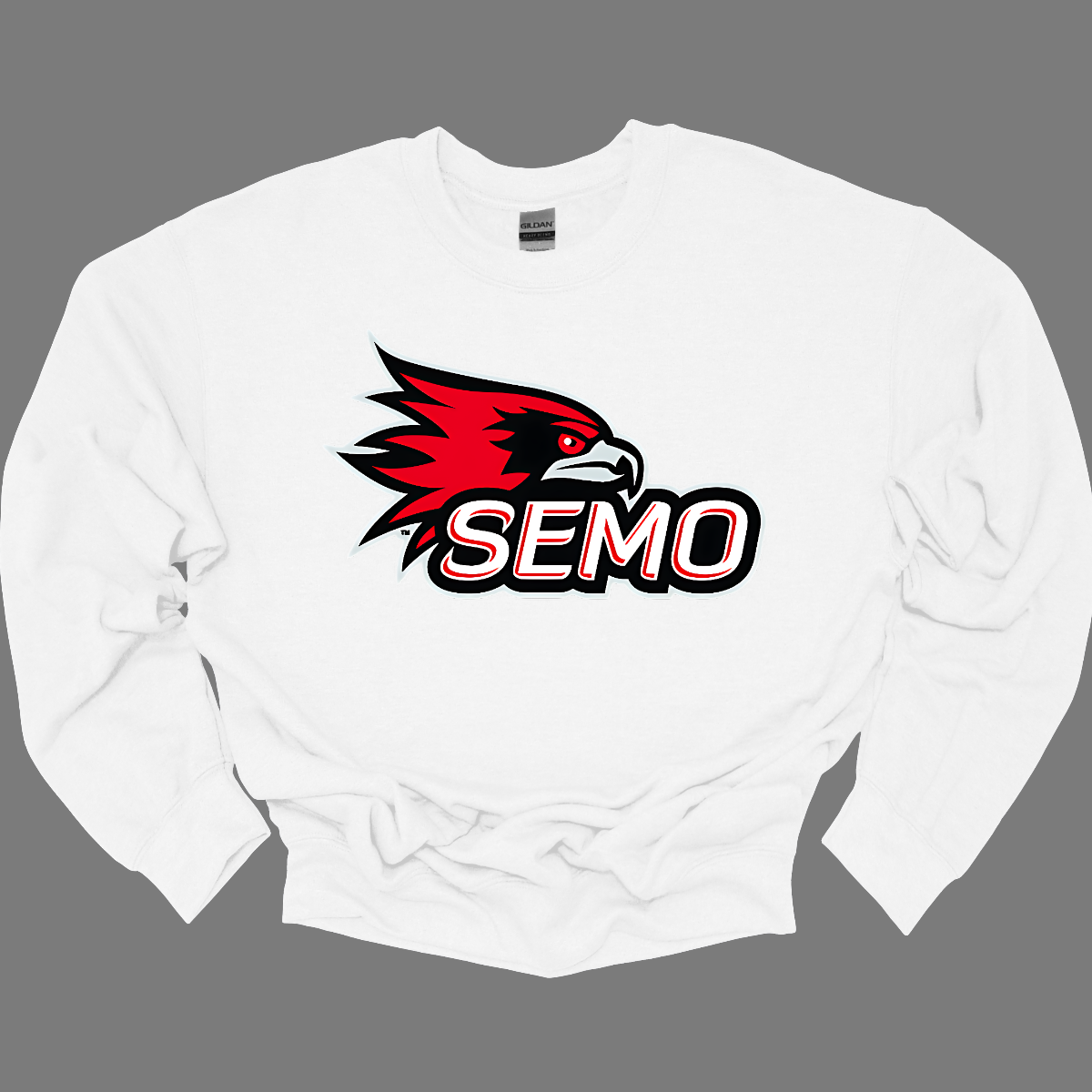 The apparel design for SEMO (Southeast Missouri State University) features the bold and iconic SEMO Redhawk logo prominently displayed across the chest or front. The Redhawk logo typically showcases a fierce red hawk in mid-flight or in a dynamic, stylized form, using shades of red, black, and white. Below this powerful symbol, the word "SEMO" is written in the university's signature font, often in all capital letters. Shop at Gorgeousware.com