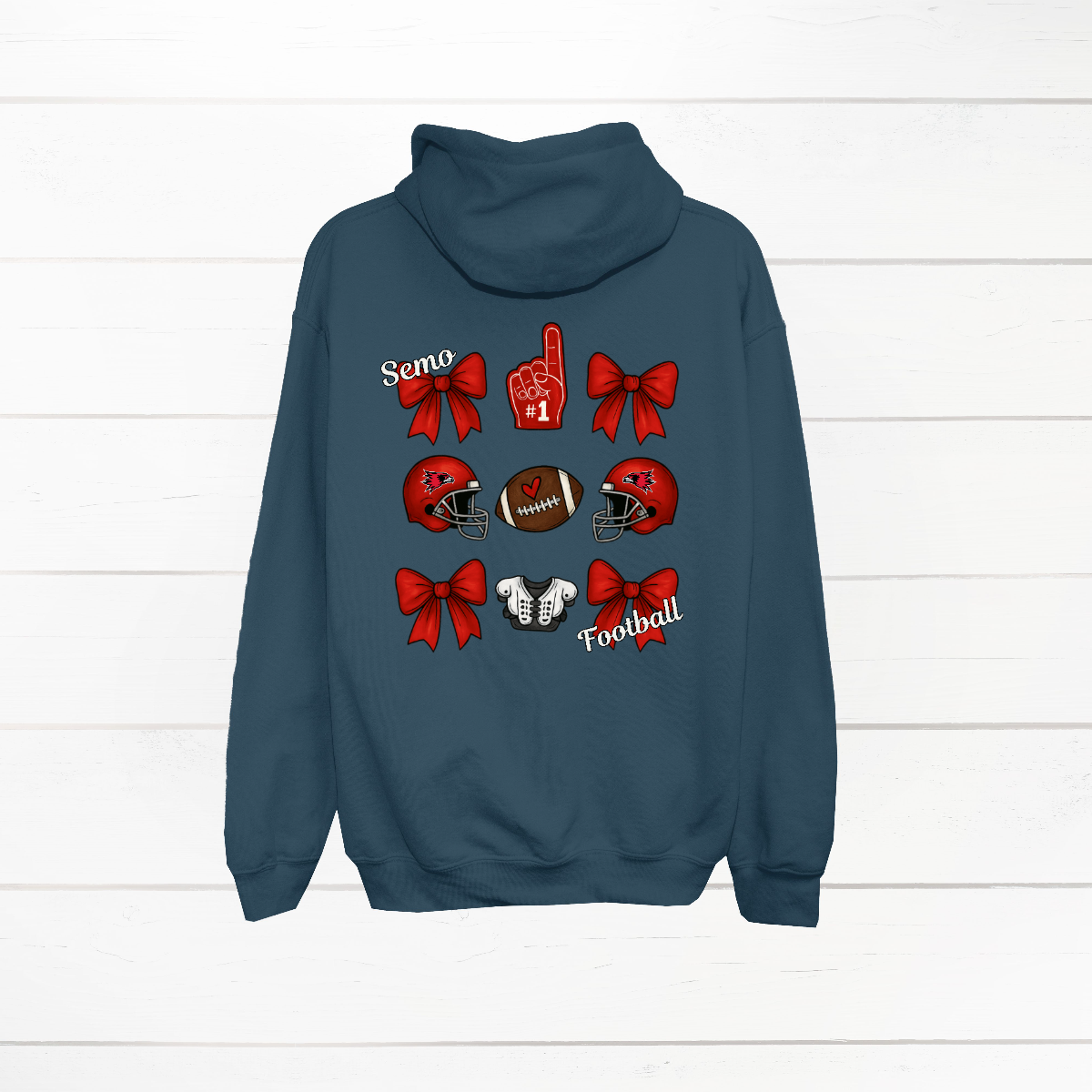 This SEMO Football Bow Grid design is available in crewneck, and hoodie options.
Front Design: A chic red croquette bow sits on the upper left chest, accented with bold white “SEMO” lettering.
Back Design: A playful grid layout showcases an exciting mix of Redhawk game-day icons—red croquette bows, SEMO football helmets, sturdy shoulder pads, and the classic #1 foam hand—all celebrating SEMO’s winning spirit.
Shop at Gorgeousware.com today!