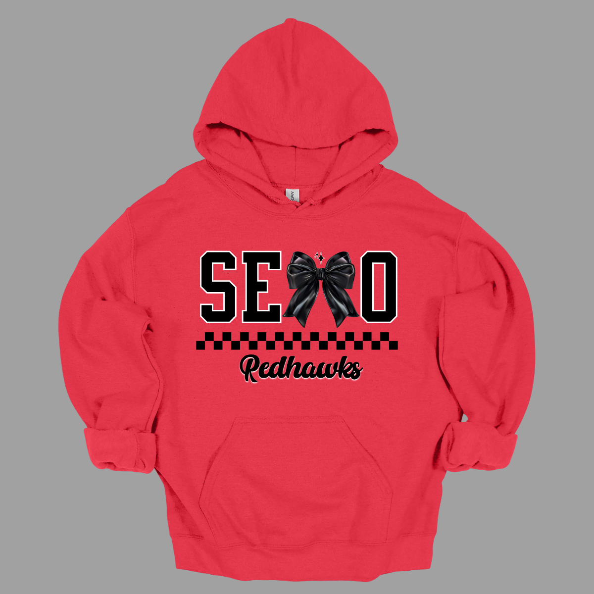 Show off your SEMO pride in style with this trendy creneck and hoodie! Featuring the bold letters "SEMO," where the "M" is cleverly replaced by a stylish black croquette bow, this shirt adds a unique twist to your wardrobe. Underneath, a playful checkerboard stripe adds a fun touch, while "Redhawks" is elegantly written in a cute cursive font, bringing a touch of flair. Shop at Gorgeousware.com