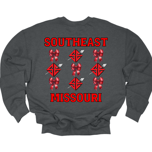 **The front will have a bow on the left chest pocket area.
Show off your collegiate pride with our SEMO Sagamore Bow! With a grid pattern of red croquette bows and the SE spear logo, the word "southeast" displayed on the top and "Missouri" on the bottom, this shirt is perfect for any SEMO fan. The front pocket design features a matching red croquette bow. Available in short or long sleeve options. Shop at Gorgeousware.com