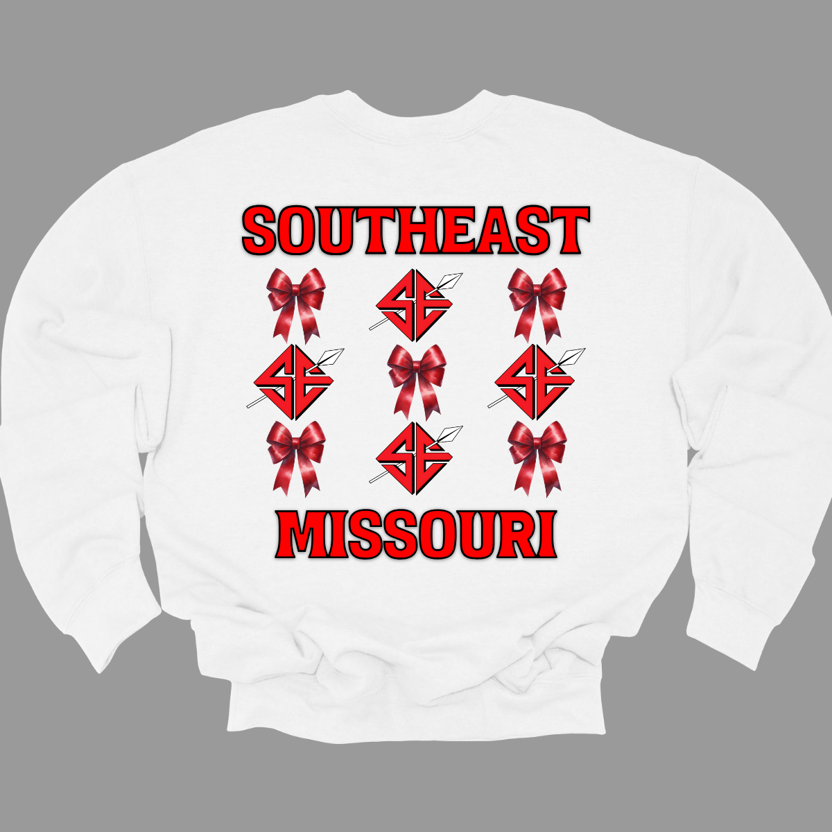 **The front will have a bow on the left chest pocket area.
Show off your collegiate pride with our SEMO Sagamore Bow! With a grid pattern of red croquette bows and the SE spear logo, the word "southeast" displayed on the top and "Missouri" on the bottom, this shirt is perfect for any SEMO fan. The front pocket design features a matching red croquette bow. Available in short or long sleeve options. Shop at Gorgeousware.com